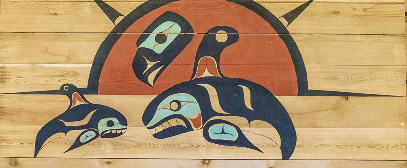 Salish coastal artwork featuring the sun and orcas